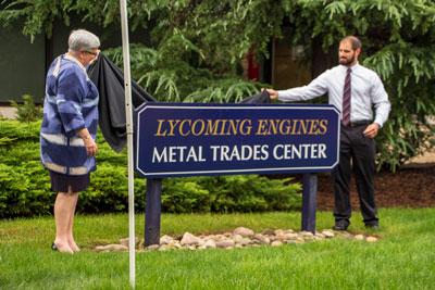 Gilmour and Bitterman unveil the new Lycoming Engines Metal Trades Center sign.